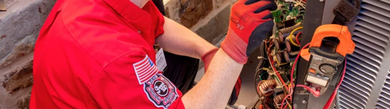 A service worker in red gloves gives a tune-up.