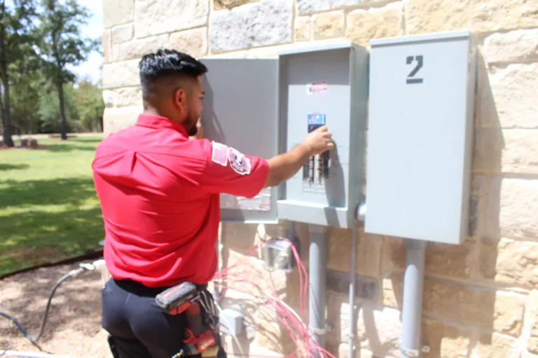 A service worker checks an outdoor electrical panel.